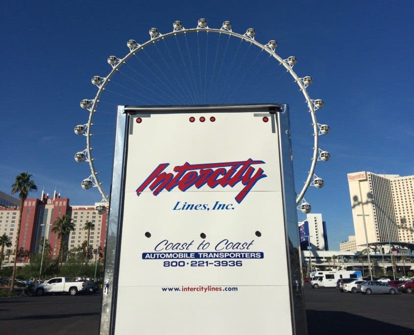car shipping Back of Intercity Lines truck in front of Ferris Wheel